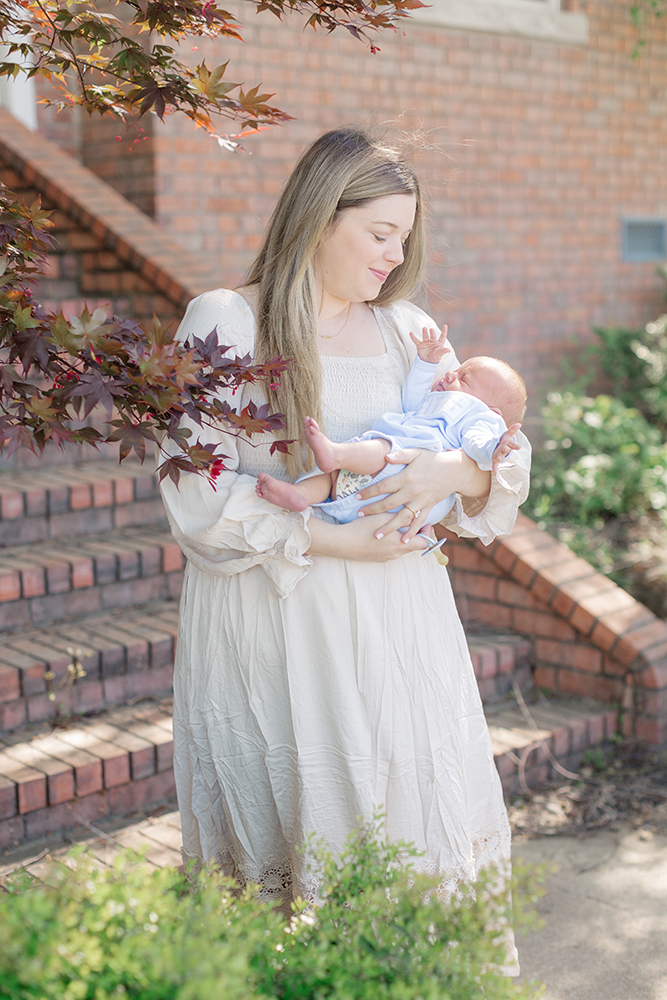 mother smiling at newborn during at home portrait session