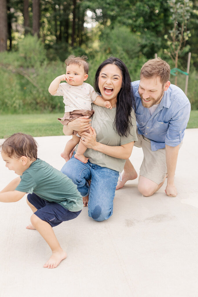 parent laughing with kids in the backyard