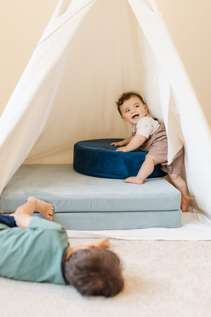 toddlers playing in a tent