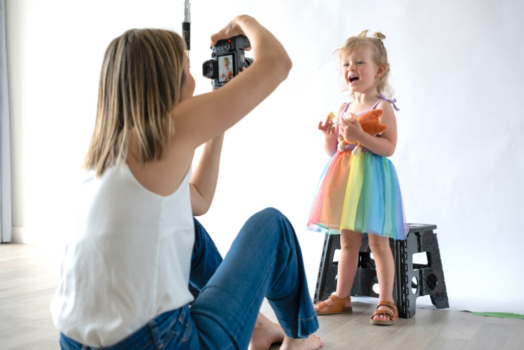 toddler laughing during playful five minute portrait session in studio